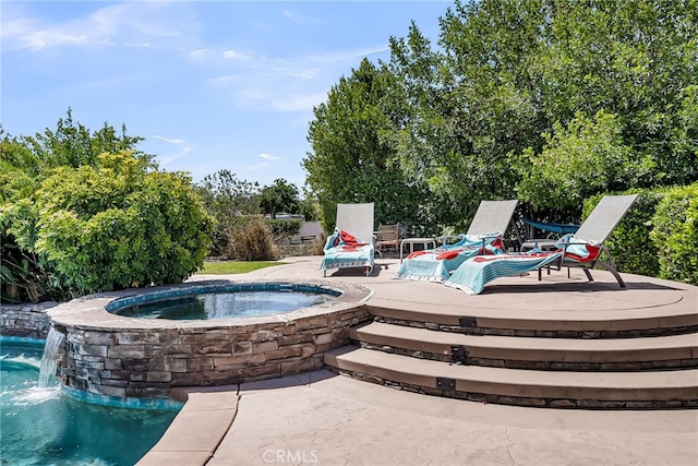 view of pool featuring a pool with connected hot tub and a deck