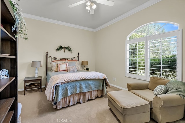 carpeted bedroom with crown molding, baseboards, and a ceiling fan