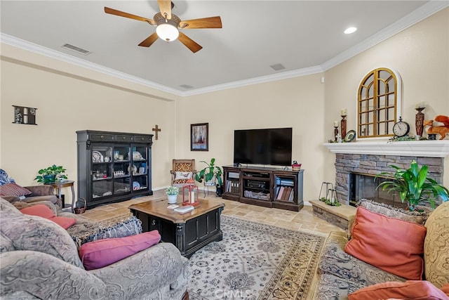 living area featuring a stone fireplace, stone tile flooring, ornamental molding, ceiling fan, and baseboards