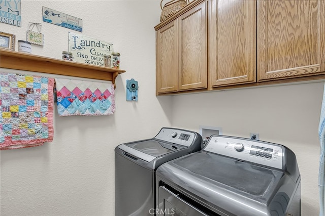 laundry room with washer and clothes dryer and cabinet space