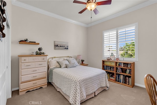 bedroom with light colored carpet, crown molding, baseboards, and ceiling fan