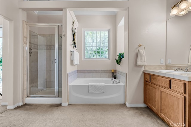 bathroom featuring a stall shower, vanity, a garden tub, baseboards, and carpet flooring