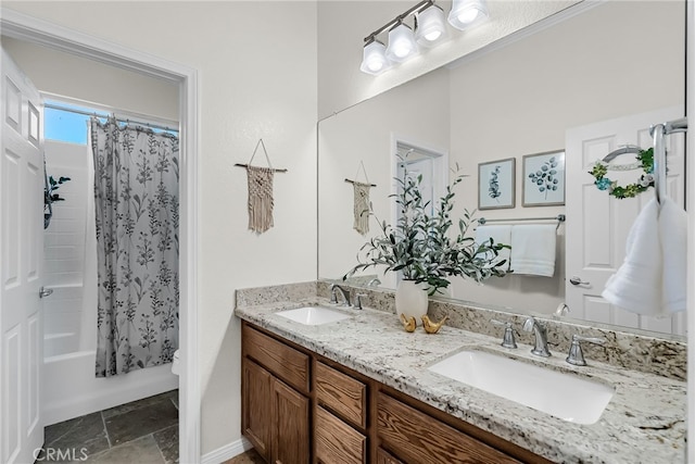 bathroom with double vanity, shower / tub combo with curtain, and stone finish flooring