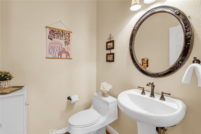 bathroom featuring toilet and a sink