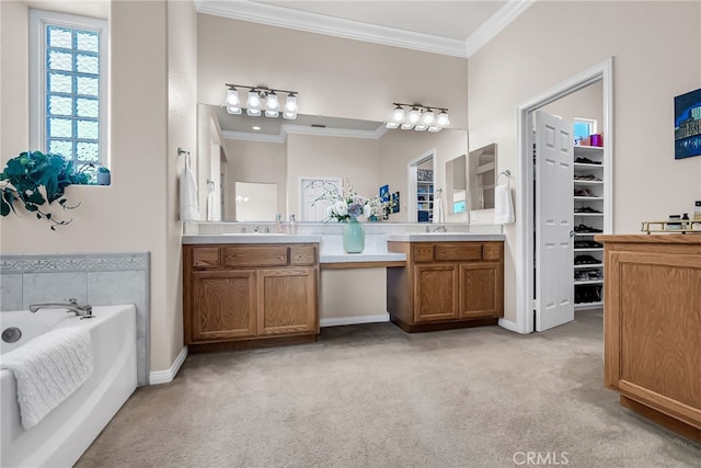 bathroom with ornamental molding, a garden tub, carpet floors, vanity, and a walk in closet