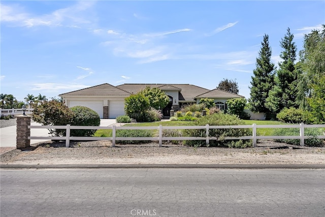 view of front facade with a garage, a fenced front yard, concrete driveway, and a tile roof