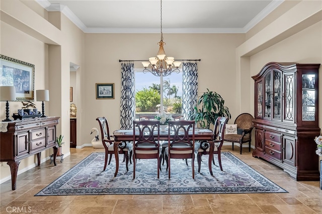 dining area featuring a chandelier, stone tile floors, crown molding, and baseboards