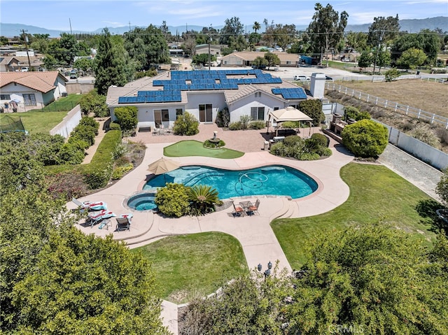 view of pool with a patio area and a pool with connected hot tub