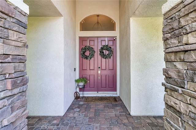 property entrance featuring stucco siding