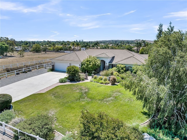 view of front of property featuring driveway, a tiled roof, and a garage