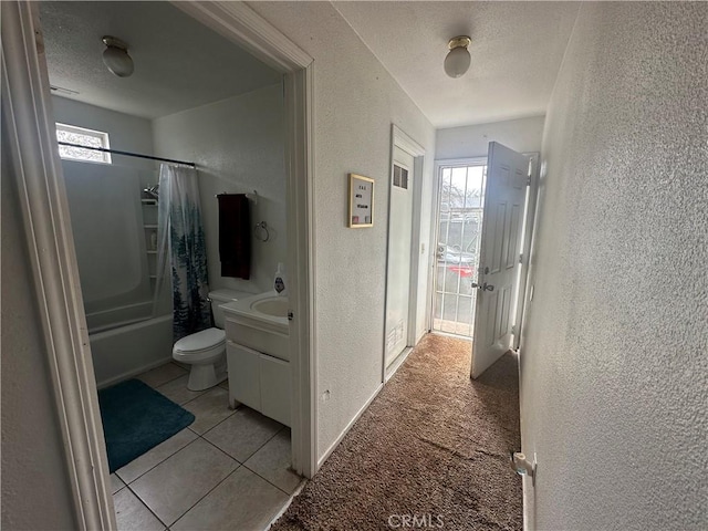 2789 Spencer Ave, Oroville, CA 95966 - hallway with a textured wall, healthy amount of natural light, a textured ceiling, tile patterned floors, and baseboards