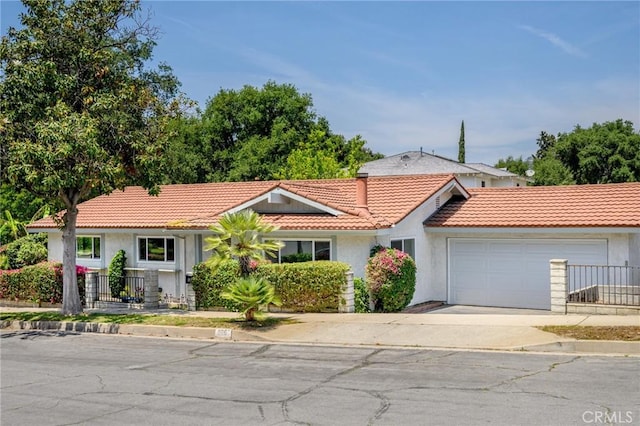 575 Winona Way, Pasadena, CA 91103 - view of front of house with a tiled roof, concrete driveway, a garage, and stucco siding