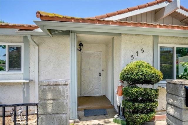 575 Winona Way, Pasadena, CA 91103 - property entrance with a tile roof, stucco siding, and board and batten siding