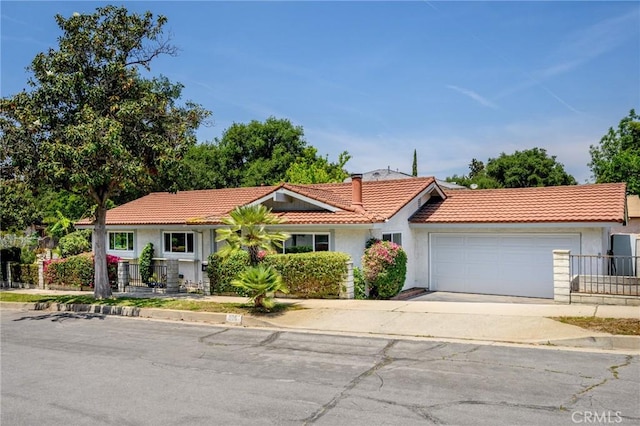 575 Winona Way, Pasadena, CA 91103 - view of front facade featuring a tiled roof, an attached garage, a chimney, concrete driveway, and stucco siding