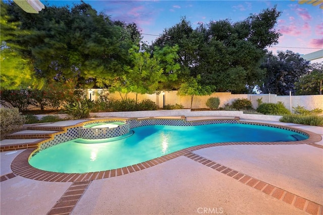 2148 Aquinas Ave, Claremont, CA 91711 - pool at dusk featuring a fenced backyard, a patio area, and a pool with connected hot tub
