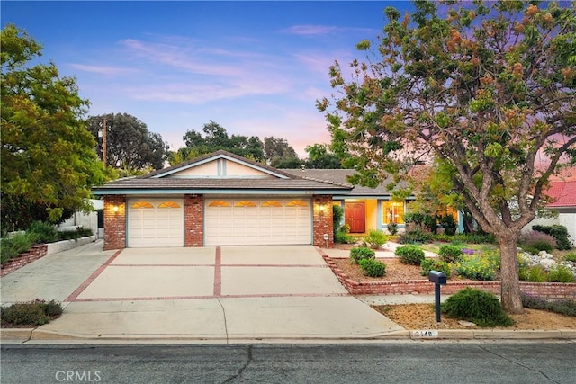 2148 Aquinas Ave, Claremont, CA 91711 - single story home with an attached garage, driveway, and brick siding