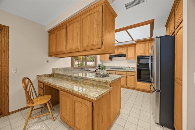 2148 Aquinas Ave, Claremont, CA 91711 - kitchen featuring black appliances, a peninsula, light tile patterned floors, a sink, and under cabinet range hood
