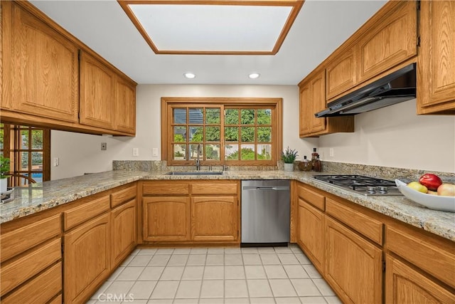 2148 Aquinas Ave, Claremont, CA 91711 - kitchen with stainless steel appliances, under cabinet range hood, brown cabinets, a sink, and light tile patterned floors