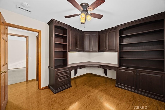 2148 Aquinas Ave, Claremont, CA 91711 - unfurnished office with dark wood-style flooring, built in desk, a ceiling fan, and baseboards