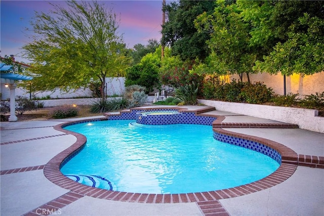 2148 Aquinas Ave, Claremont, CA 91711 - pool at dusk featuring a fenced backyard, a patio, and a pool with connected hot tub