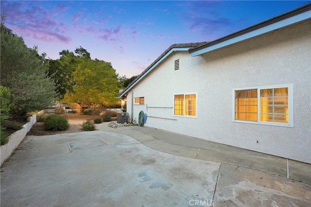 2148 Aquinas Ave, Claremont, CA 91711 - view of side of property featuring stucco siding, a patio area, and central AC unit