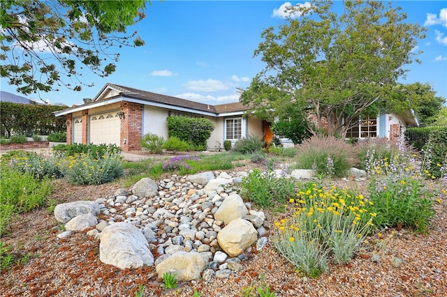 2148 Aquinas Ave, Claremont, CA 91711 - view of front of house featuring an attached garage, stucco siding, and brick siding
