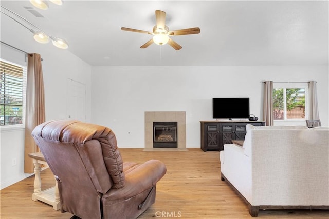 16702 Hastings Pl, Victorville, CA 92395 - living area with a ceiling fan, light wood-style floors, and a fireplace