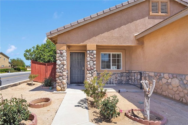 16702 Hastings Pl, Victorville, CA 92395 - view of exterior entry with stucco siding and stone siding