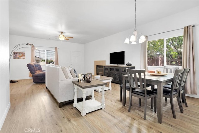 16702 Hastings Pl, Victorville, CA 92395 - living area featuring light wood-style flooring, a chandelier, plenty of natural light, and baseboards