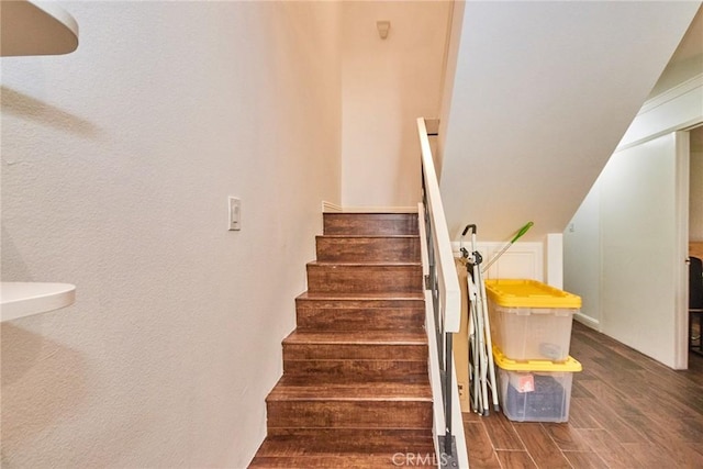 stairs featuring wood finished floors