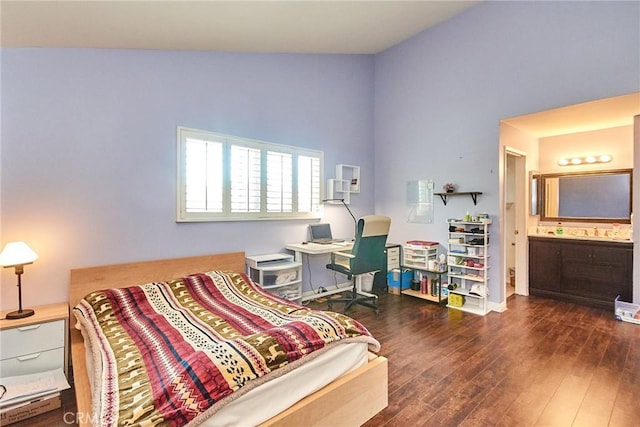 bedroom featuring wood finished floors and ensuite bath
