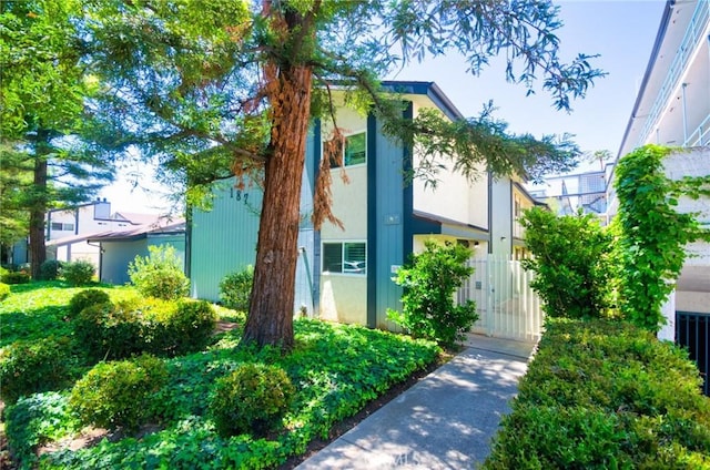 view of property exterior featuring a gate and stucco siding