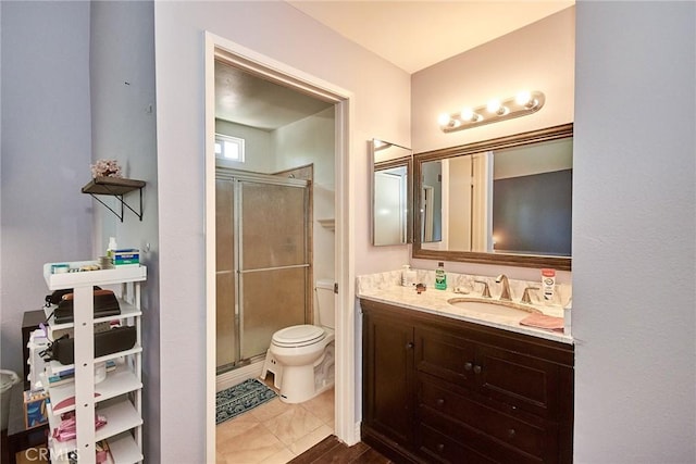 full bathroom with a stall shower, toilet, and vanity