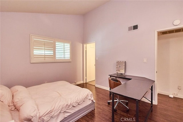 bedroom with dark wood-style flooring, baseboards, an office area, and vaulted ceiling
