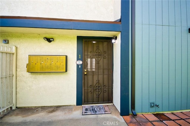 entrance to property with stucco siding