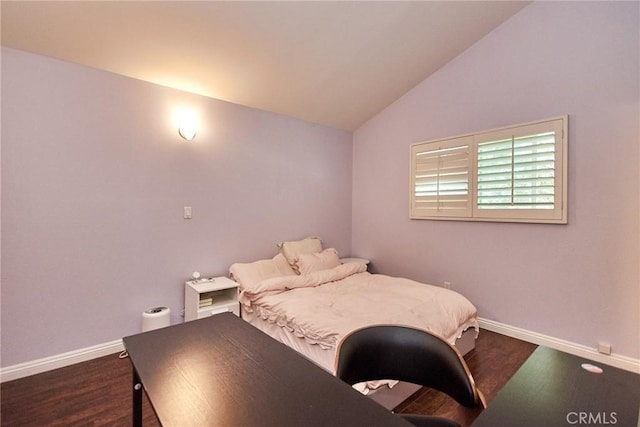 bedroom with baseboards, dark wood-style flooring, and vaulted ceiling