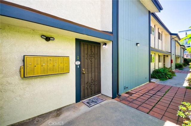 entrance to property with stucco siding