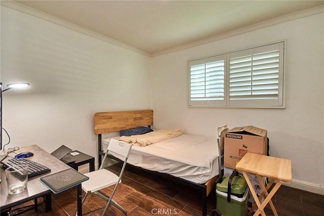 bedroom featuring wood finished floors, ornamental molding, baseboards, and an office area