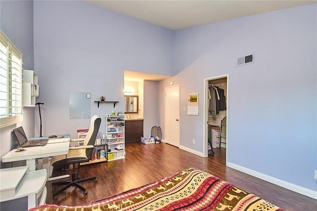 office with a high ceiling, wood finished floors, and baseboards