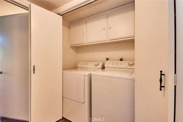 laundry room featuring washer and dryer and cabinet space