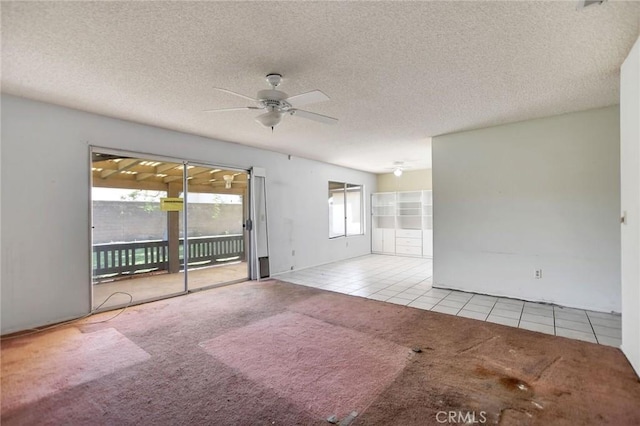 638 W Villa Chaparral Rd, San Jacinto, CA 92583 - unfurnished room with tile patterned flooring, a ceiling fan, carpet, and a textured ceiling