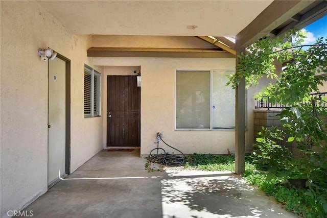 638 W Villa Chaparral Rd, San Jacinto, CA 92583 - view of exterior entry featuring a patio area and stucco siding