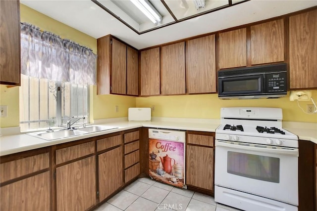 638 W Villa Chaparral Rd, San Jacinto, CA 92583 - kitchen featuring black microwave, white range with gas cooktop, a sink, and light countertops