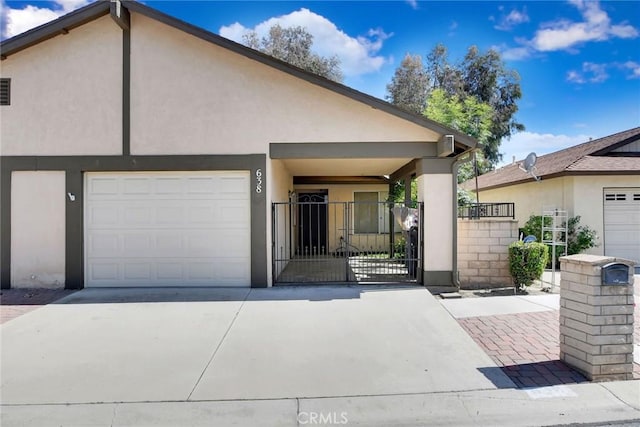 638 W Villa Chaparral Rd, San Jacinto, CA 92583 - multi unit property featuring concrete driveway, stucco siding, a gate, and an attached garage