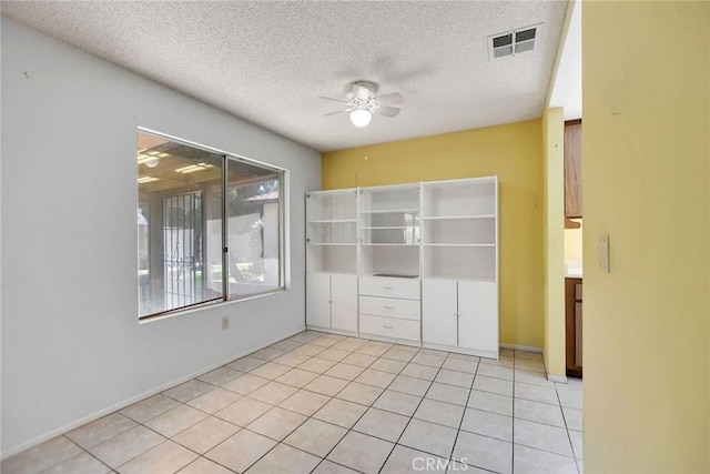 638 W Villa Chaparral Rd, San Jacinto, CA 92583 - empty room with ceiling fan, a textured ceiling, tile patterned floors, and baseboards