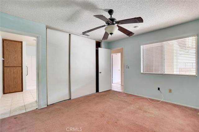 638 W Villa Chaparral Rd, San Jacinto, CA 92583 - unfurnished bedroom with light carpet, a closet, a textured ceiling, and a ceiling fan