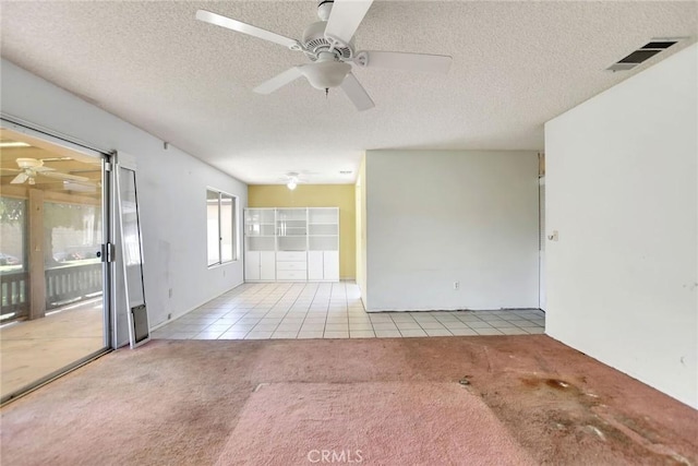 638 W Villa Chaparral Rd, San Jacinto, CA 92583 - empty room featuring carpet flooring, a ceiling fan, tile patterned floors, and a textured ceiling