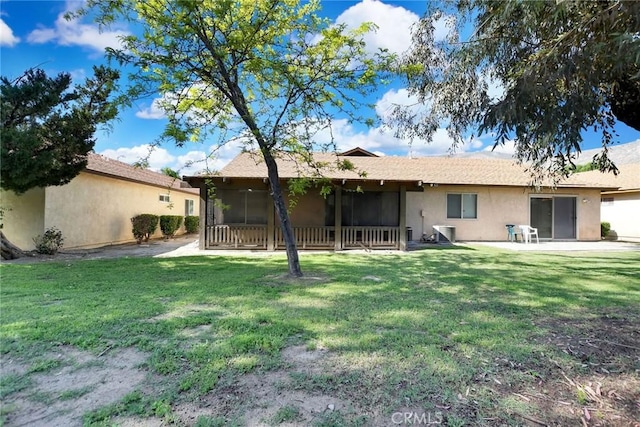 638 W Villa Chaparral Rd, San Jacinto, CA 92583 - back of house featuring stucco siding, a yard, and a sunroom