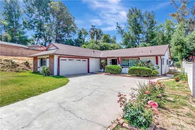ranch-style house with a garage, concrete driveway, and a shingled roof