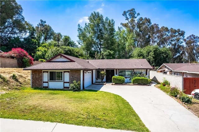 ranch-style home with driveway, an attached garage, and brick siding